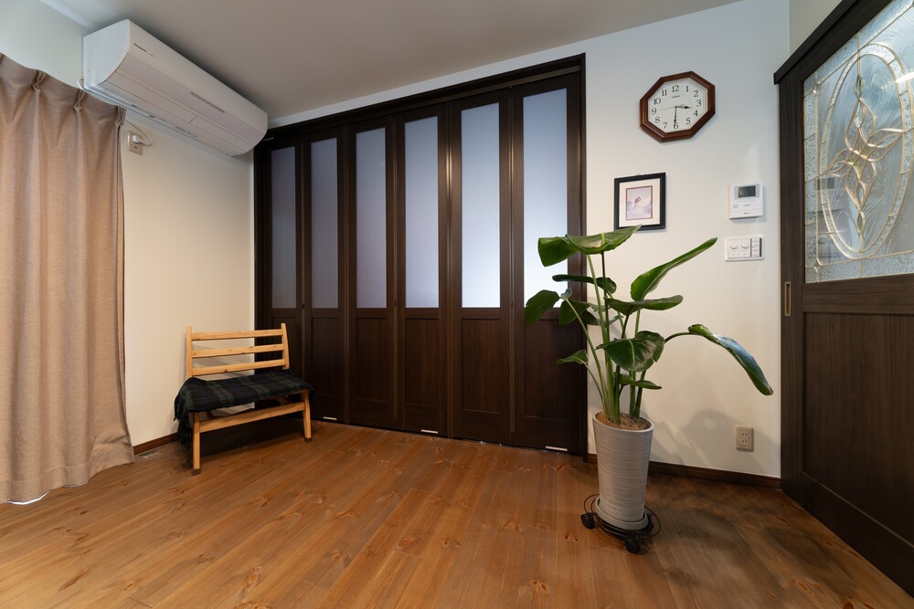 高さのある間仕切り折れ戸とステンドグラスの引き戸